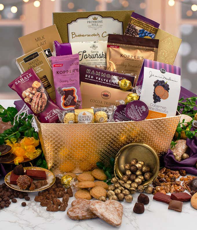Gourmet chocolate and sweets gift basket with assorted truffles, cookies, chocolate-covered nuts, pecans, gummy bears, cocoa truffles, Ferrero Rocher, butterscotch candies, and wine biscuits displayed in a decorative gold container.