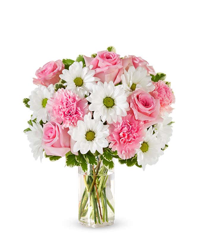 Pink roses, pink carnations and white daisies in a pink vase