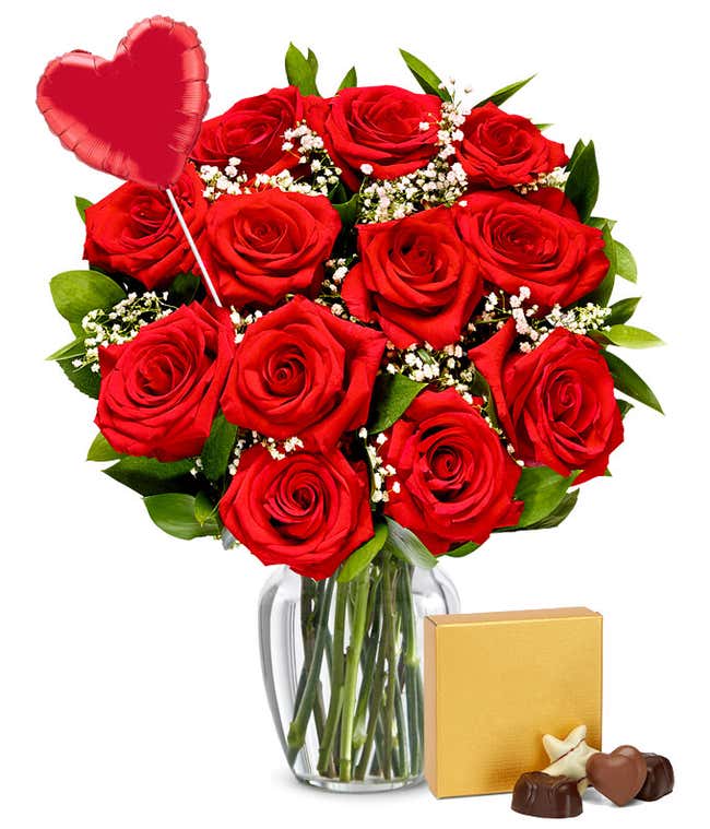 One dozen red roses with a heart balloon and teddy bear