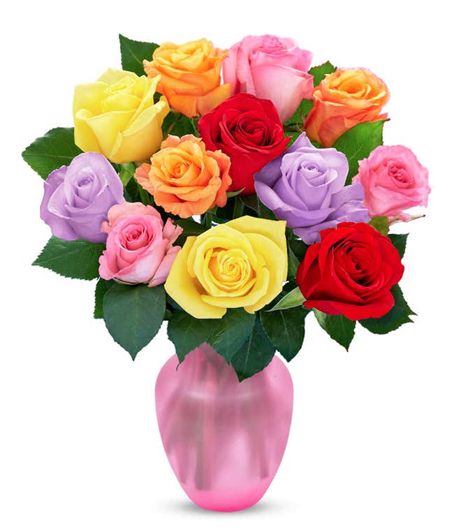 A bouquet of multicolored roses in a clear vase, featuring red, pink, orange, yellow, peach, and lavender blooms, arranged with green leaves for a vibrant and cheerful display.