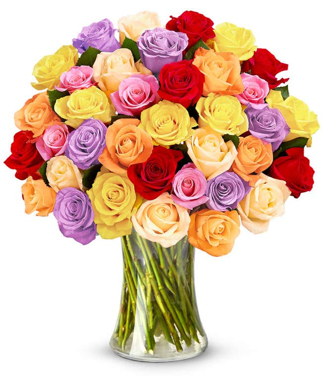 A bouquet of 36 roses in an array of red, orange, cream, yellow, pink, and lavender. In a clear glass vase. 