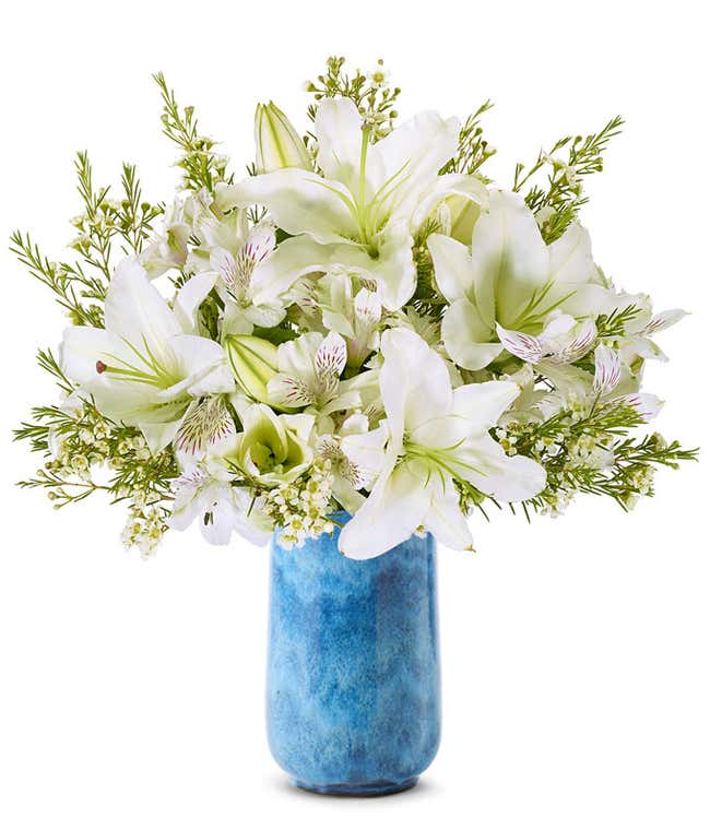 White lilies, white alstroemeria and white wax flowers