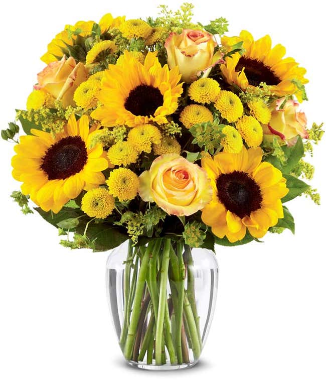 A vibrant arrangement featuring yellow/orange bi-color roses, sunflowers, yellow button poms, yellow solidago, and bupleurum, optionally presented in a vase. This cheerful display brings a burst of sunshine and joy to any occasion.