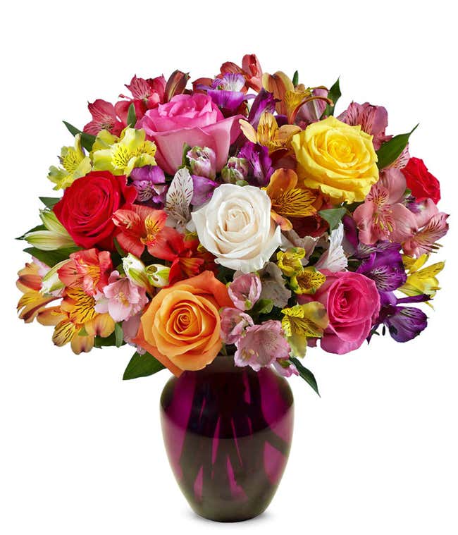 A beautiful arrangement featuring mixed roses and assorted alstroemeria, optionally presented in a glass vase. This vibrant mix offers a colorful and cheerful display, perfect for any occasion.
