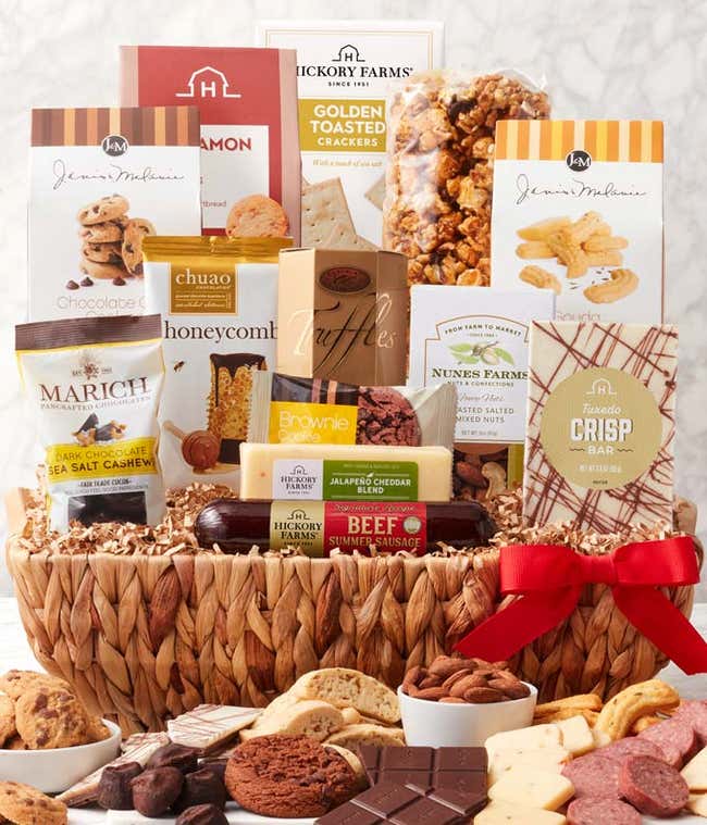 Woven gift basket with gourmet snacks: butter toffee pretzels, salted caramel popcorn, biscotti, toasted crackers, dark chocolate cashews, chocolate chip cookies, honeycomb chocolates, truffles, cheddar cheese, beef sausage, almonds, cheese straws, and a 