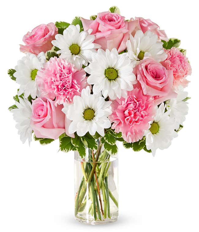 Pink roses, pink carnations and white daisies in a pink vase