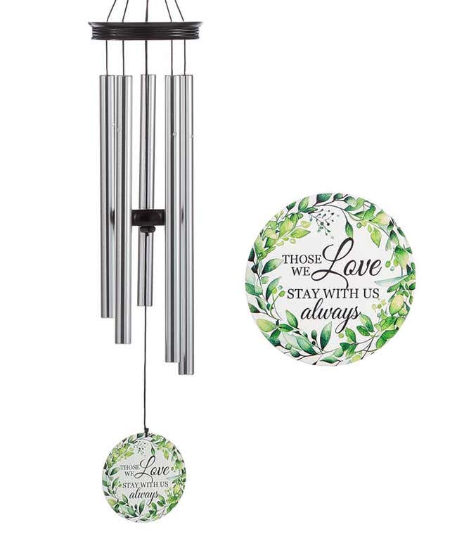 A windchime with metal rods with wooden accents and sail. Sail reads those we love stay with us always with green leaf accents.