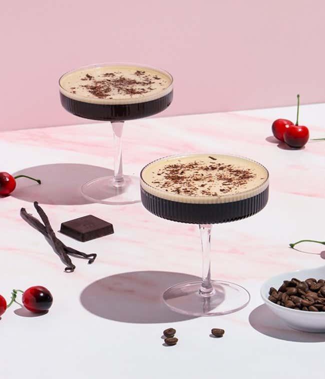 The cocktail kit contains a 4 oz. bottle of cherry-vanilla syrup, a 3.7mL bottle of cocoa bitters, an 11oz. can of cold brew coffee, a square of dark chocolate, and a recipe card.