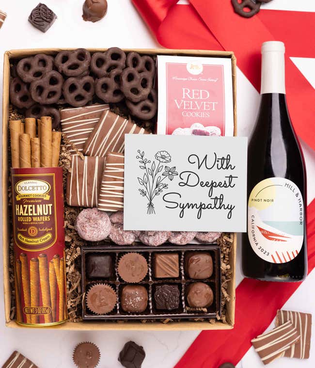 a gift box full of decadent treats with a Sympathy message card.  Contents include: a bottle of California Pinot Noir, a bag of milk chocolate pretzel, a box of mini chocolate chip cookies, and a 4-ounce box of assorted chocolates.