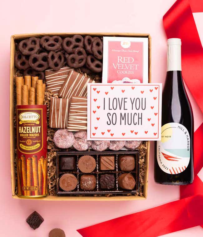 a gift box full of decadent treats with an I Love You message card.  Contents include: a bottle of California Pinot Noir, a bag of milk chocolate pretzel, a box of mini chocolate chip cookies, and a 4-ounce box of assorted chocolates.